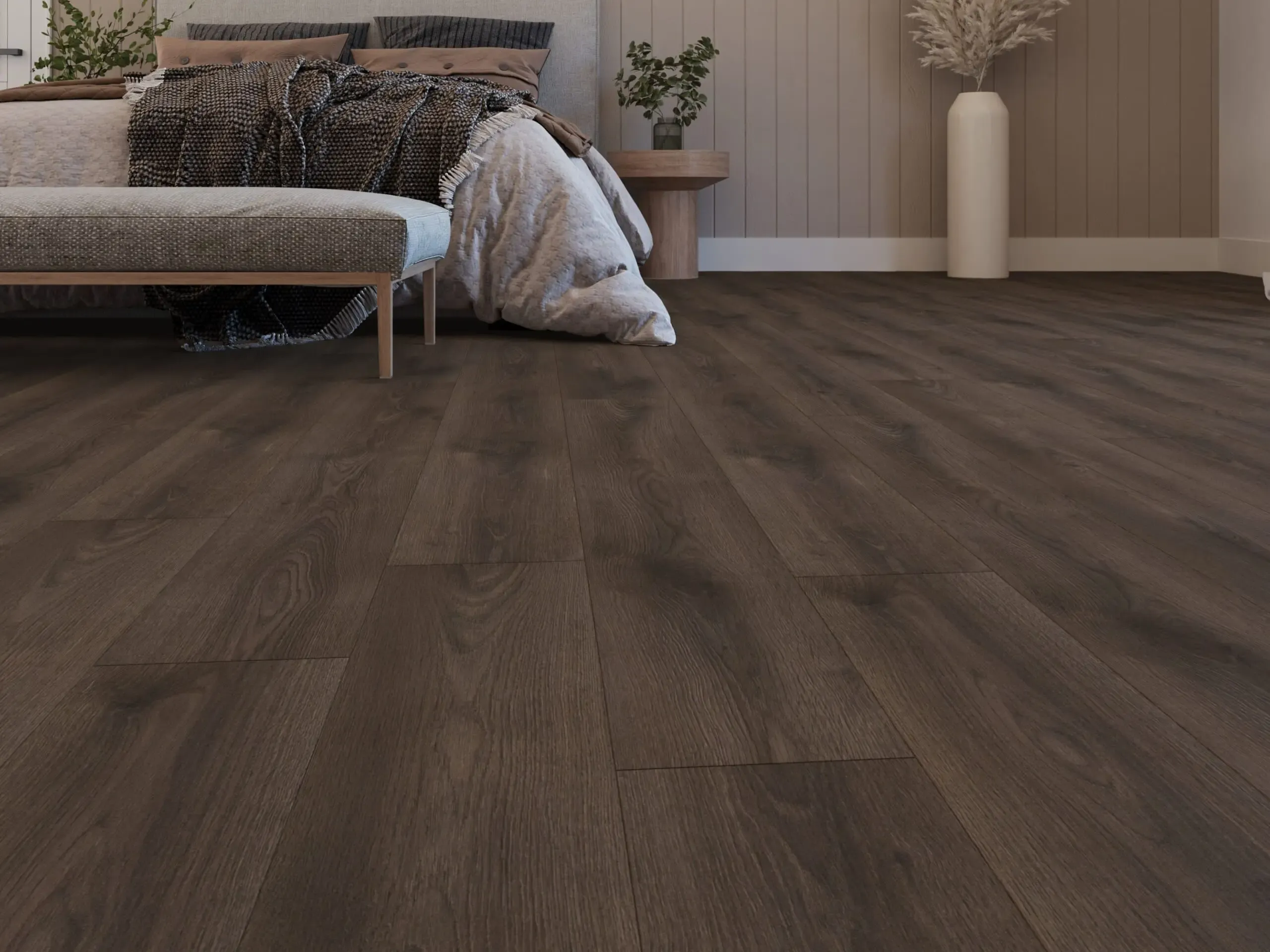 Bedroom with warm brown laminate flooring.