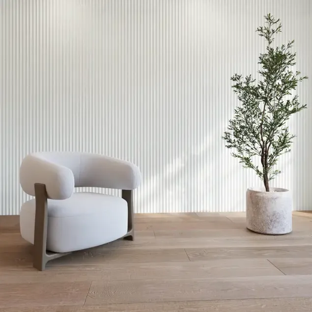 Lounge chair against a wall of vertical fluted wood panels.